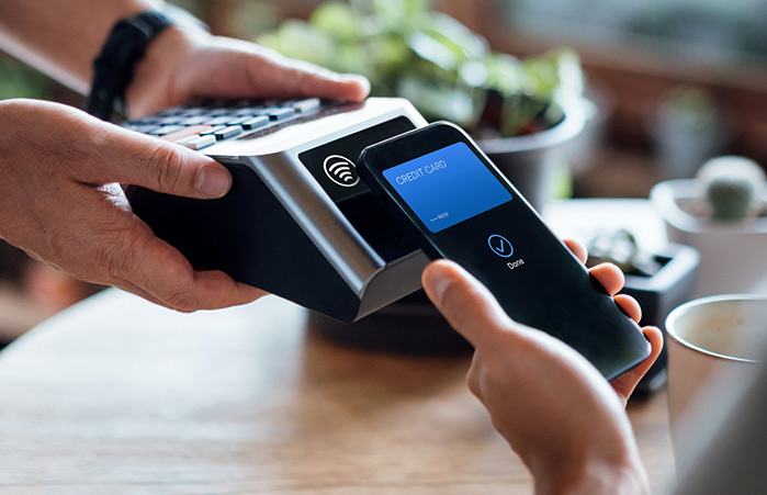 Person paying bill with their phone.