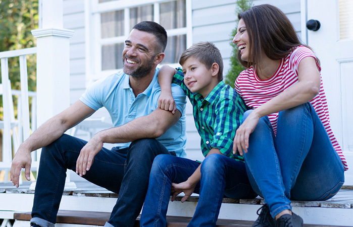 Family sitting on their porch.