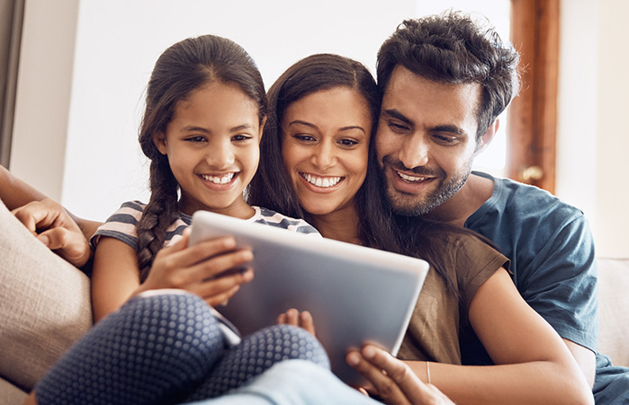 Family looking at their tablet.
